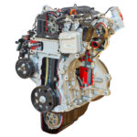 Fotografiert ist ein Benzinmotor aus dem Hause VW. Der Motor wurde zu einem Schnittmodell gemacht und auf diesem Foto ist der Blick auf die Steuerkette möglich.